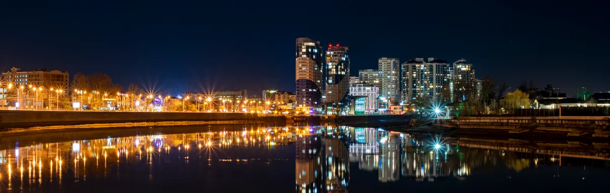 Beautiful night view of Krasnodar's skyline reflecting in the Kuban River.