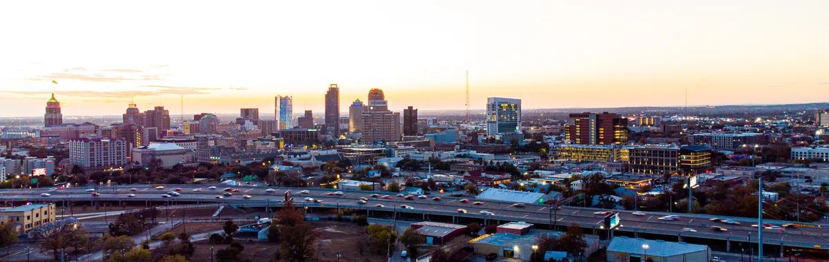 A breathtaking aerial view of San Antonio's skyline during sunset, showcasing its urban charm and high-rise buildings.
