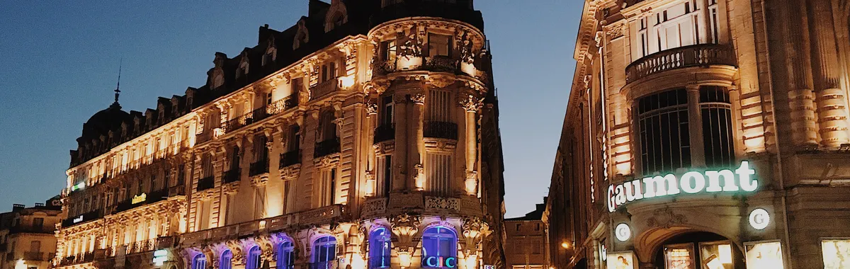 Stunning view of illuminated buildings in Montpellier's urban landscape at dusk.