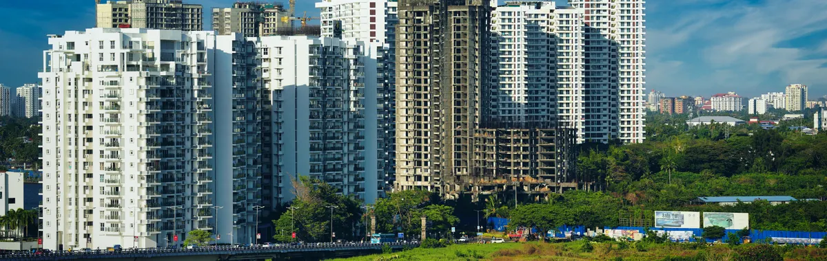 Stunning cityscape of Kochi's modern skyline with high-rise apartments and lush greenery.