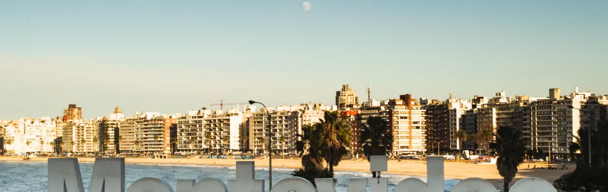 Montevideo landmark sign with city skyline and beach view, capturing Uruguay's iconic coastal urban setting.