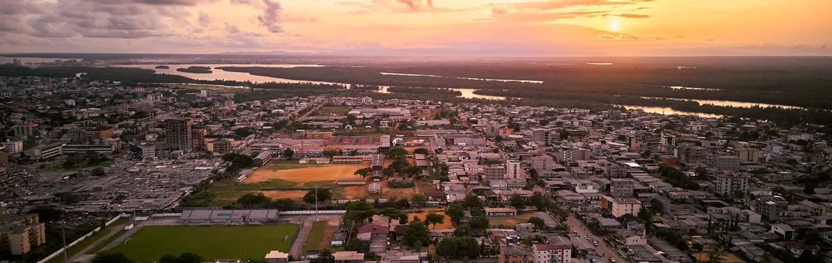 Breathtaking aerial shot of Douala, Cameroon showcasing cityscape and vibrant sunset.
