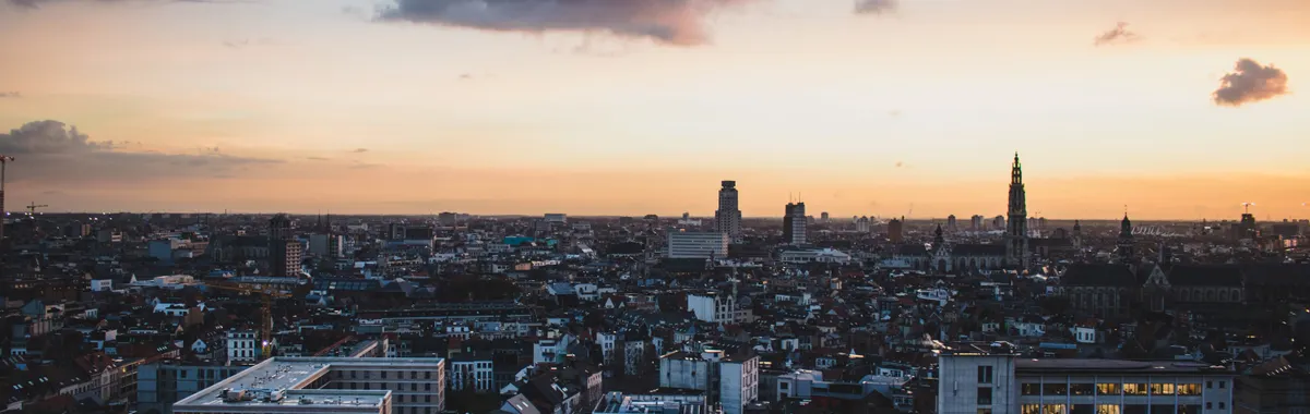 A stunning aerial view of Antwerp, Belgium, cityscape at dusk with vibrant sky colors.