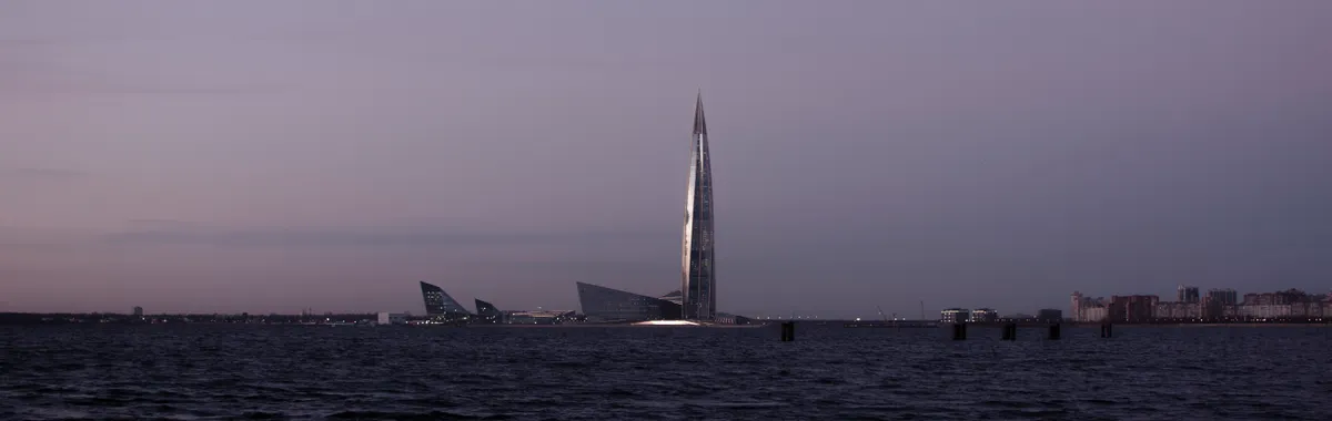 Capture of Lakhta Center skyscraper at twilight, overlooking a calm sea in St. Petersburg, Russia.