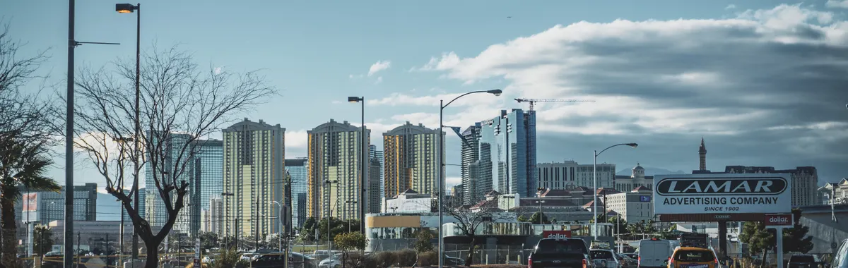 Dynamic view of Las Vegas skyline with bustling street traffic and modern skyscrapers.