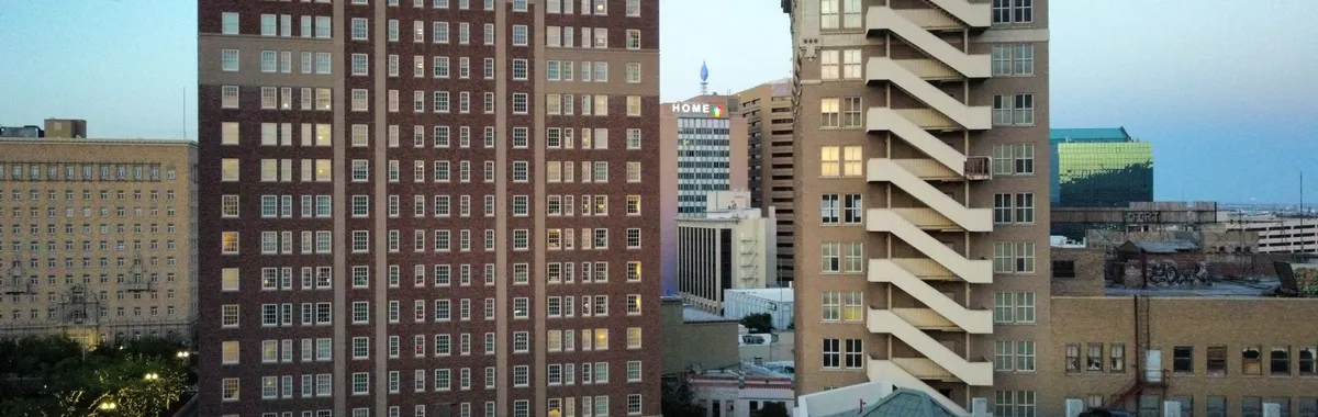 Aerial view of modern buildings in downtown El Paso at dusk.