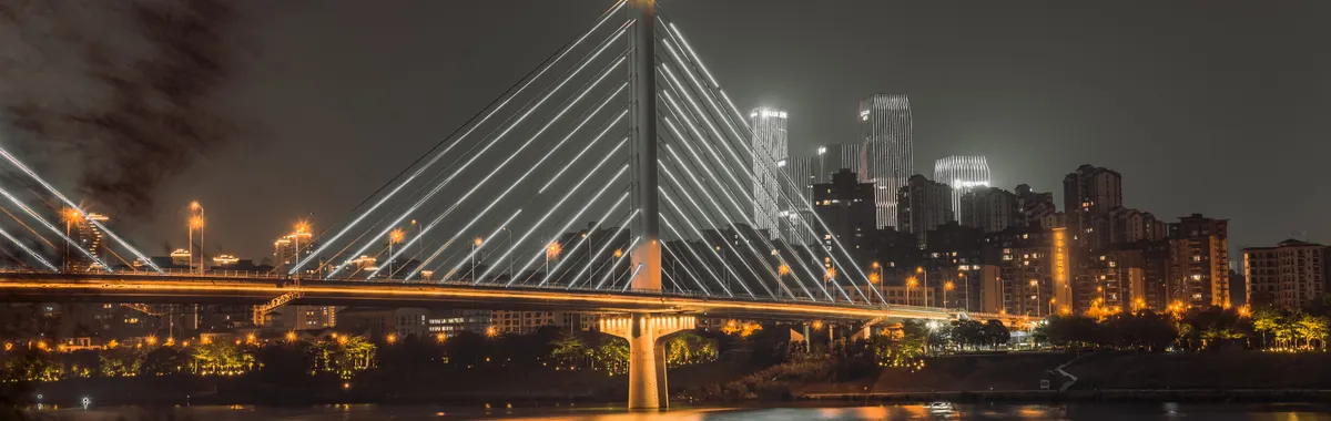 Captivating night view of a modern cable-stayed bridge in Nanning, Guangxi with city skyline.