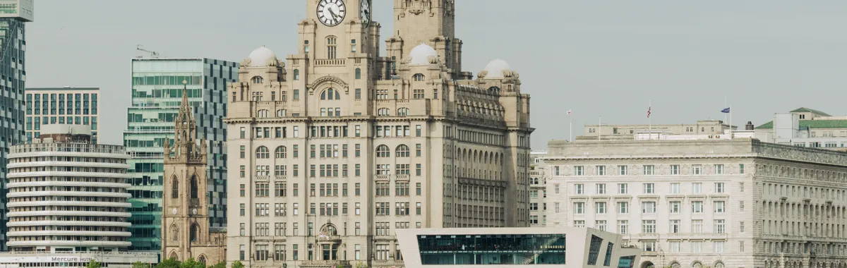 Scenic view of Liverpool's Royal Liver Building at the waterfront, showcasing architectural elegance.