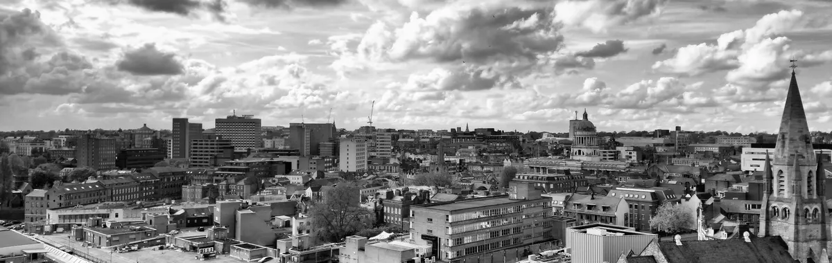 Captivating black and white aerial view of Nottingham cityscape with dramatic clouds.