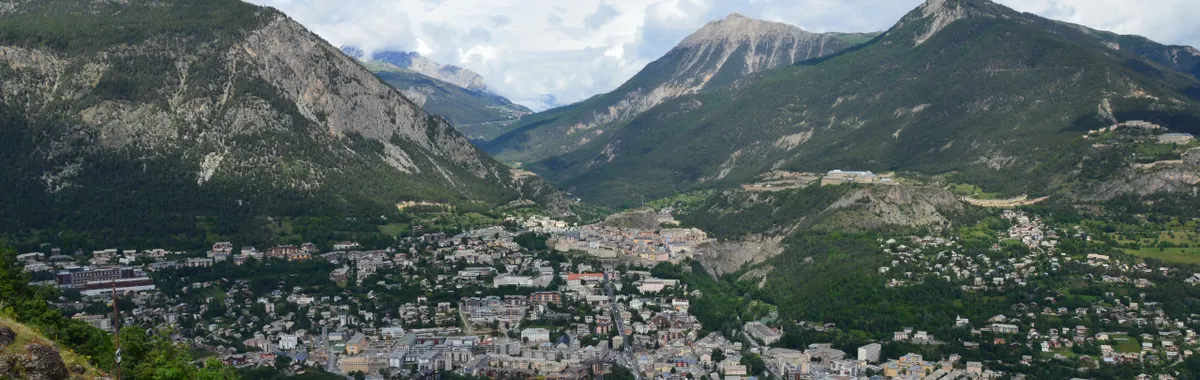 Stunning aerial shot of Puy-Saint-Pierre nestled in the French Alps, showcasing the town and mountains.