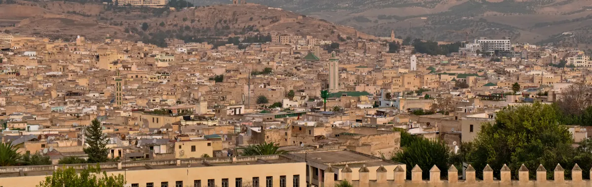 Explore the historic cityscape of Fes, Morocco, showcasing its unique architecture and sprawling urban landscape.