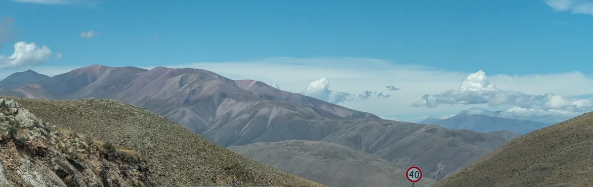 A stunning view of a winding road through mountains in San Salvador de Jujuy, Argentina.