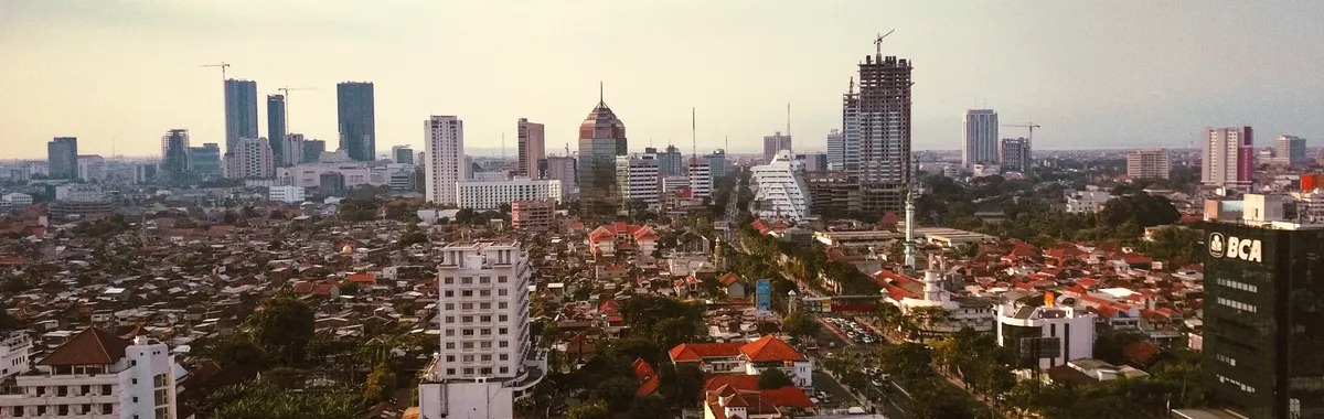 Stunning aerial view of Surabaya cityscape with skyscrapers and vibrant urban life.