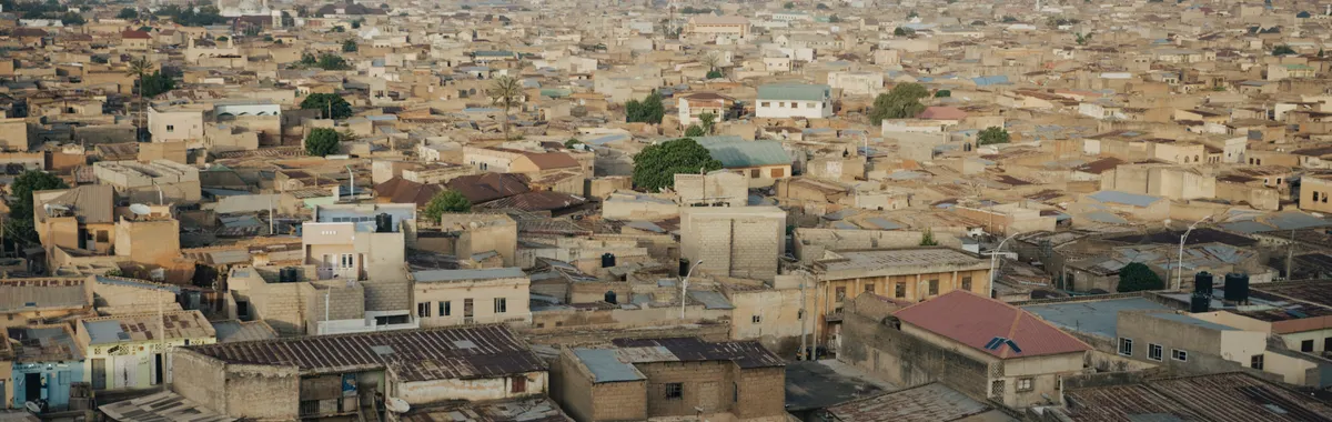 Aerial cityscape of Kano, Nigeria showcasing dense urban architecture and sprawling rooftops.