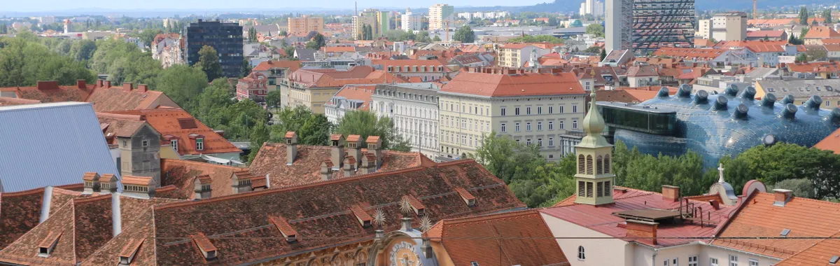 Stunning aerial view of Graz, Austria showcasing the city's iconic red rooftops and unique architecture.