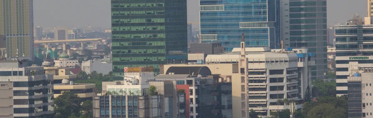 Aerial view of Jakarta's urban skyline showcasing modern skyscrapers and bustling city life.