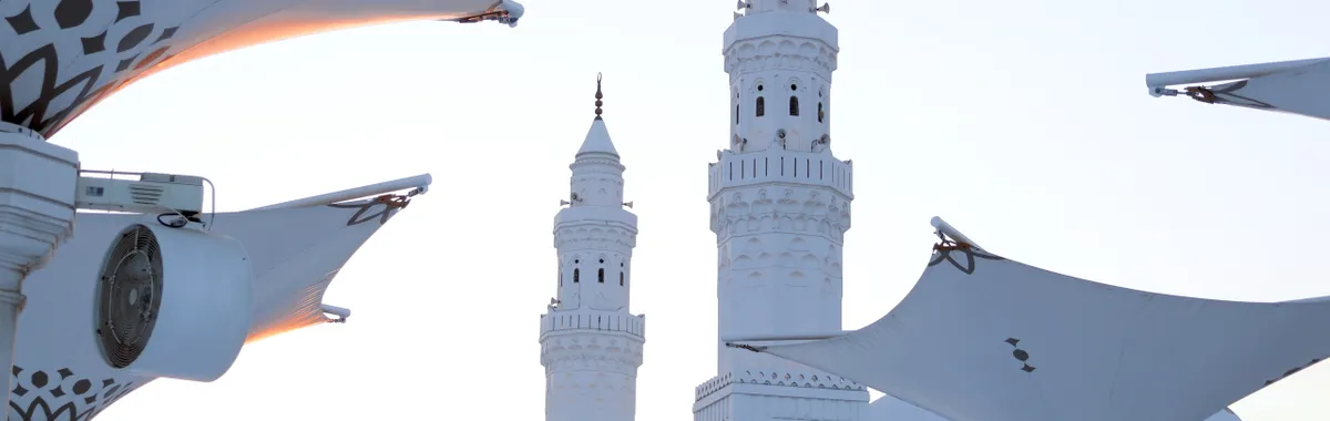 Modern architectural canopies and mosque towers in Madinah, showcasing Islamic design.