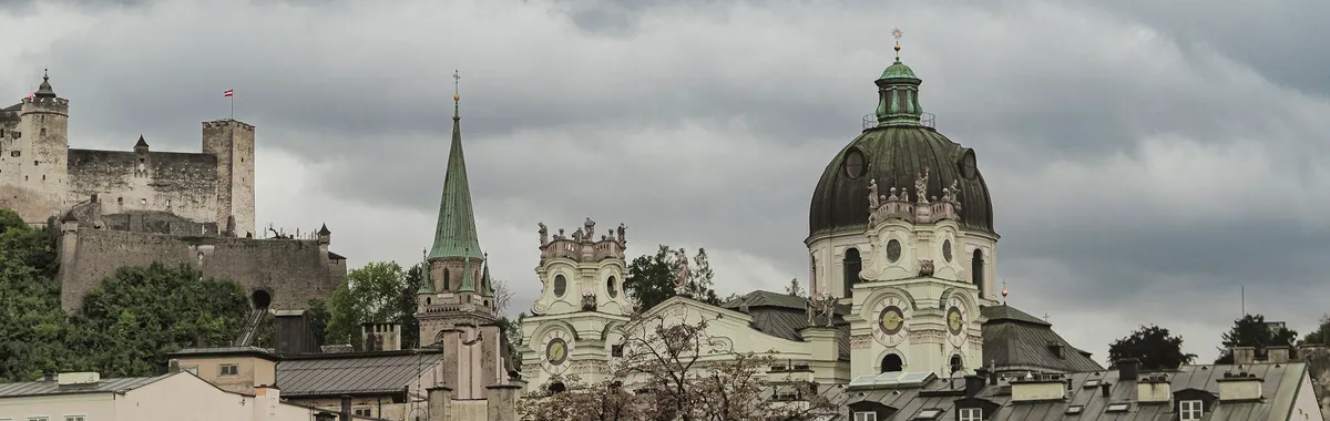 Explore the architectural charm of Salzburg's Dom Quartier with Hohensalzburg Fortress in the backdrop.