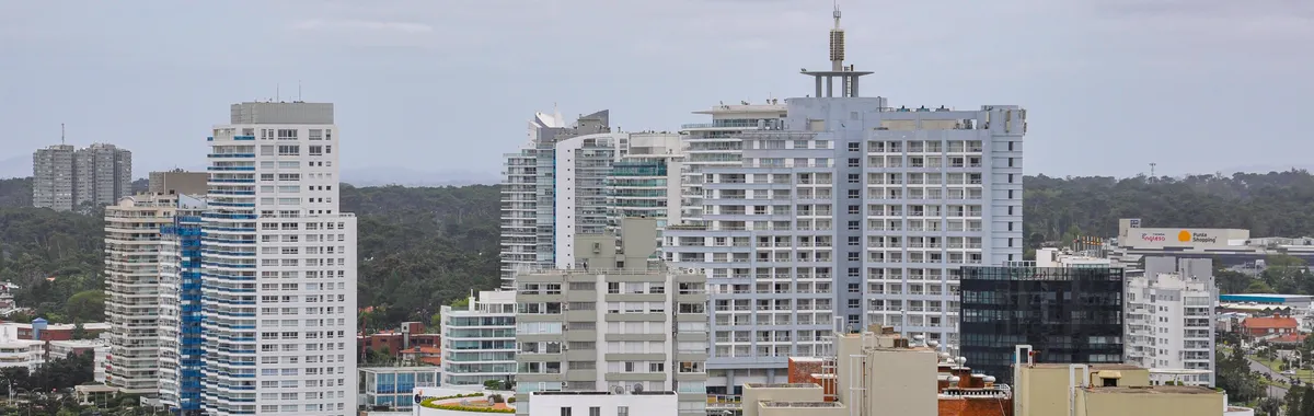 Aerial view of Punta del Este's modern skyline with tall buildings under cloudy skies.