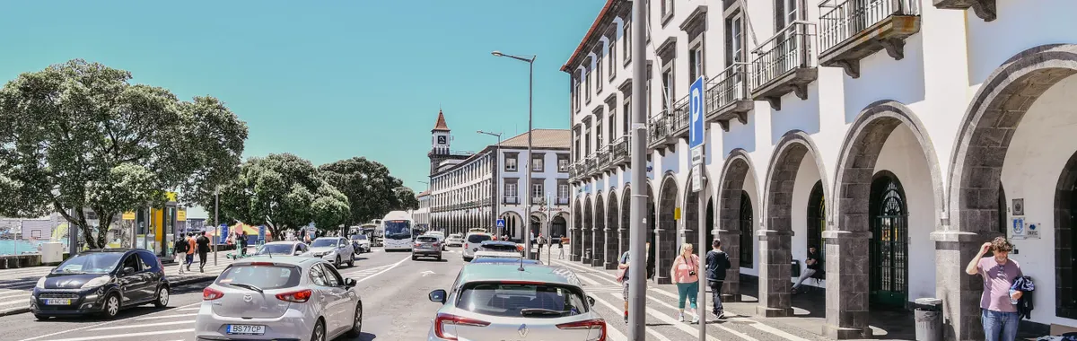 Street view of Ponta Delgada with historic architecture and bustling afternoon activity.