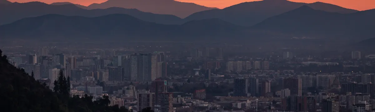 צ׳ילה: Spectacular dusk over Santiago's skyline with Andes mountains backdrop.