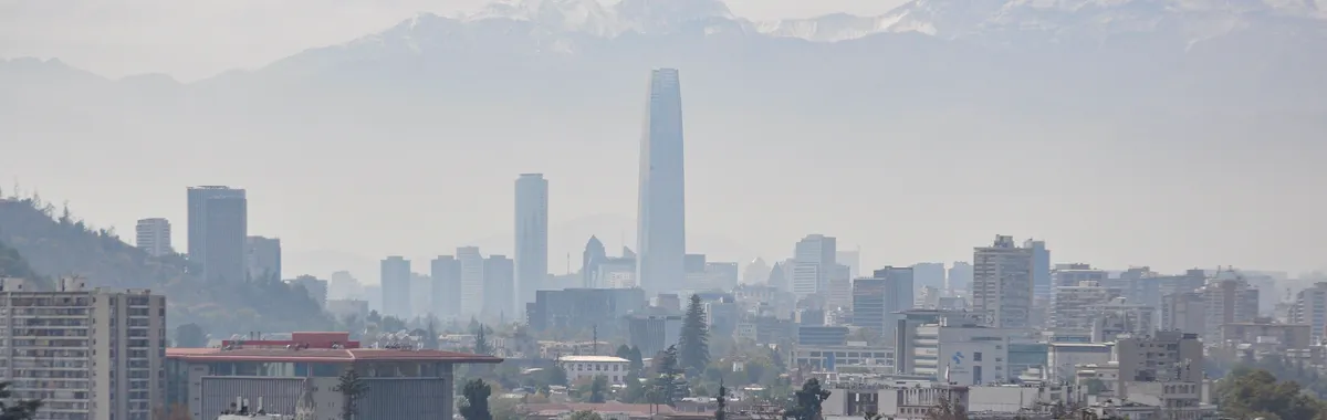 Panoramic view of Santiago's skyline with Andes mountains in the background.
