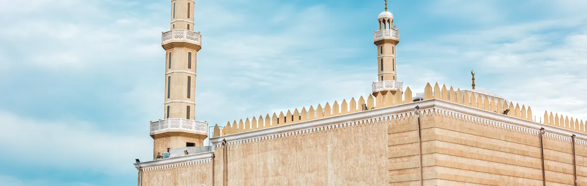 Beautiful view of a traditional mosque in Al Ahmadi, Kuwait, showcasing Islamic architecture against a clear blue sky.