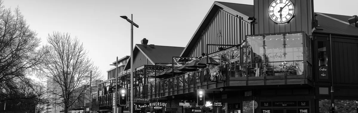 Monochrome image of Riverside Market in Christchurch, showcasing architectural details and vibrant urban vibe.