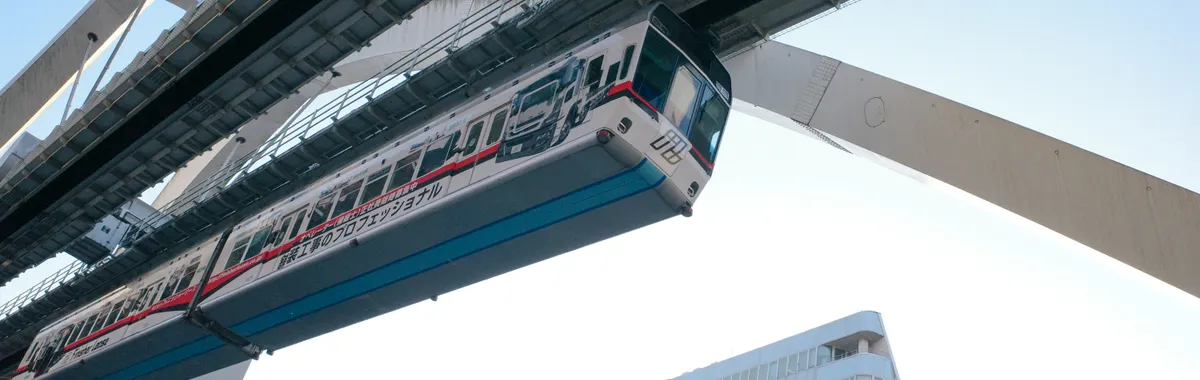 A modern monorail train passing through Chiba, Japan, showcasing urban infrastructure and transportation.