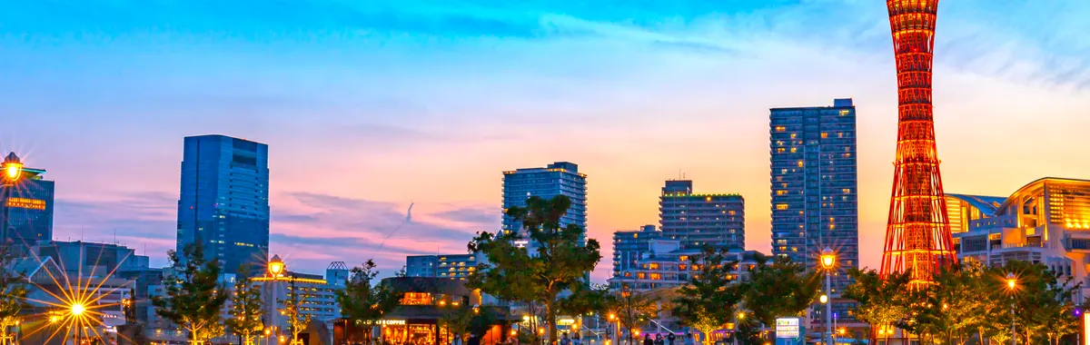 Captivating sunset view of Kobe Port Tower with vibrant cityscape in Japan.
