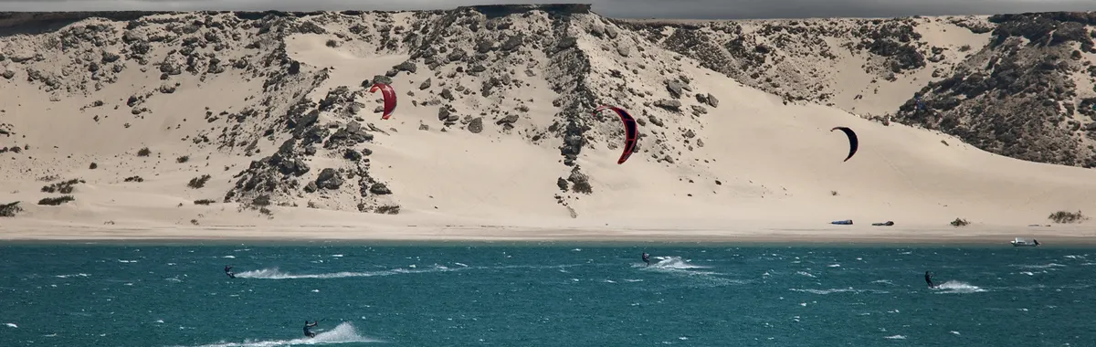Kitesurfers enjoy the winds off the sandy shores of Laâyoune, Morocco.