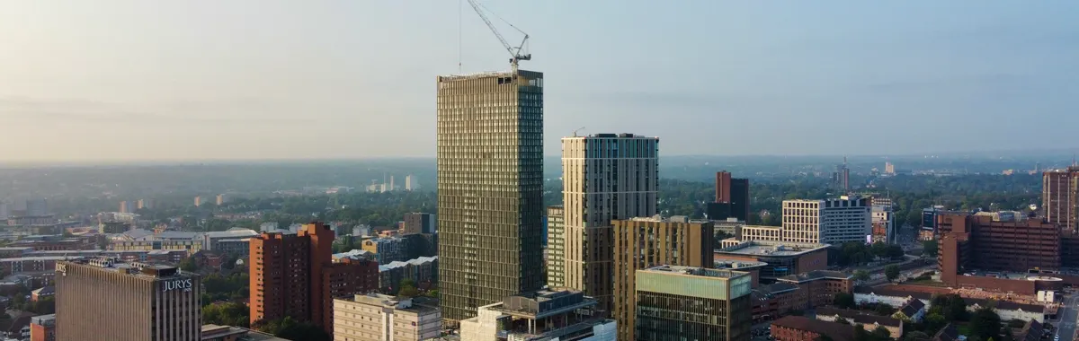 Aerial shot capturing the modern skyline of Birmingham, England during the day.